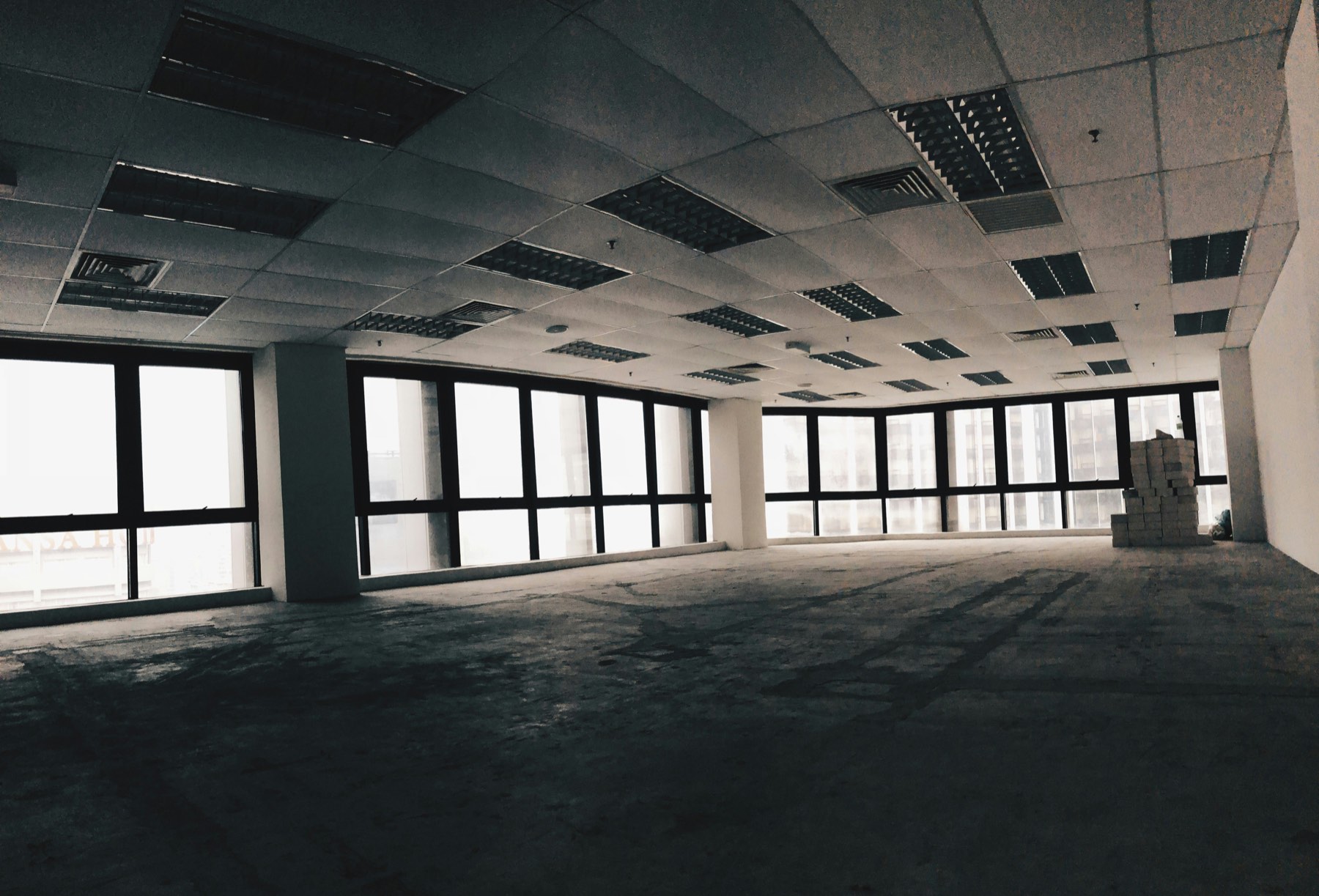 Empty office space with large windows, representing a company being wound down in Turkey